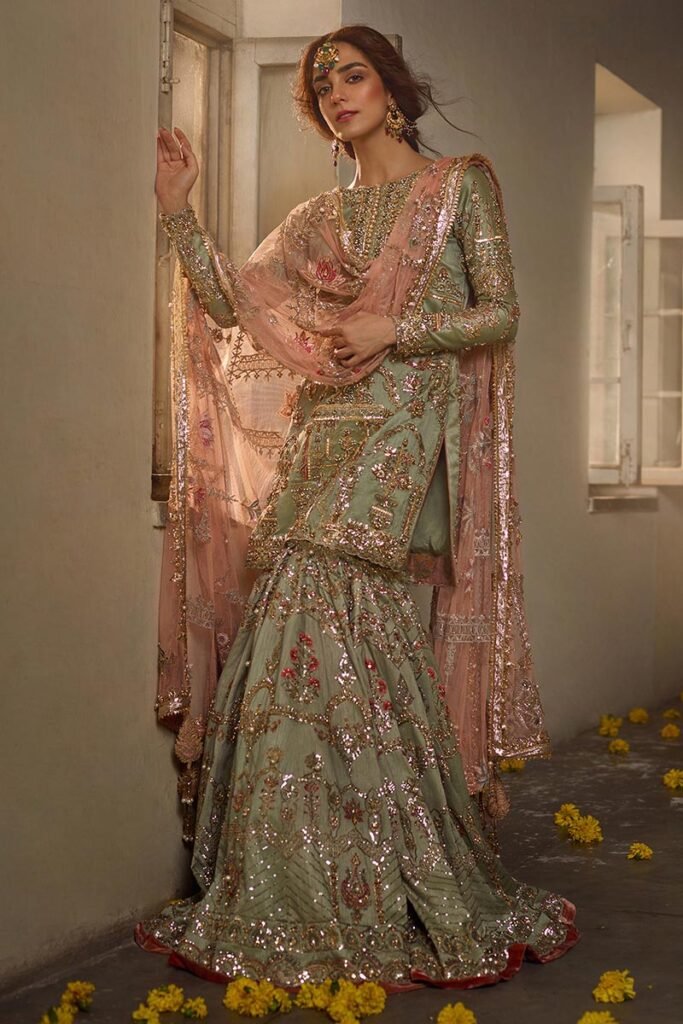 Mohsin Naveed Ranjha Zamrud Hand Embellished Raw Silk Bridal Lehenga - Model Front Look | Pakistani Designer Replica Wholesale | IQNAZ